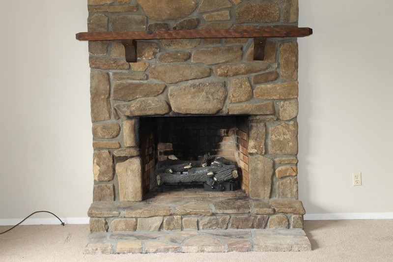 living room features stone fireplace with gas logs for chilly mountain days