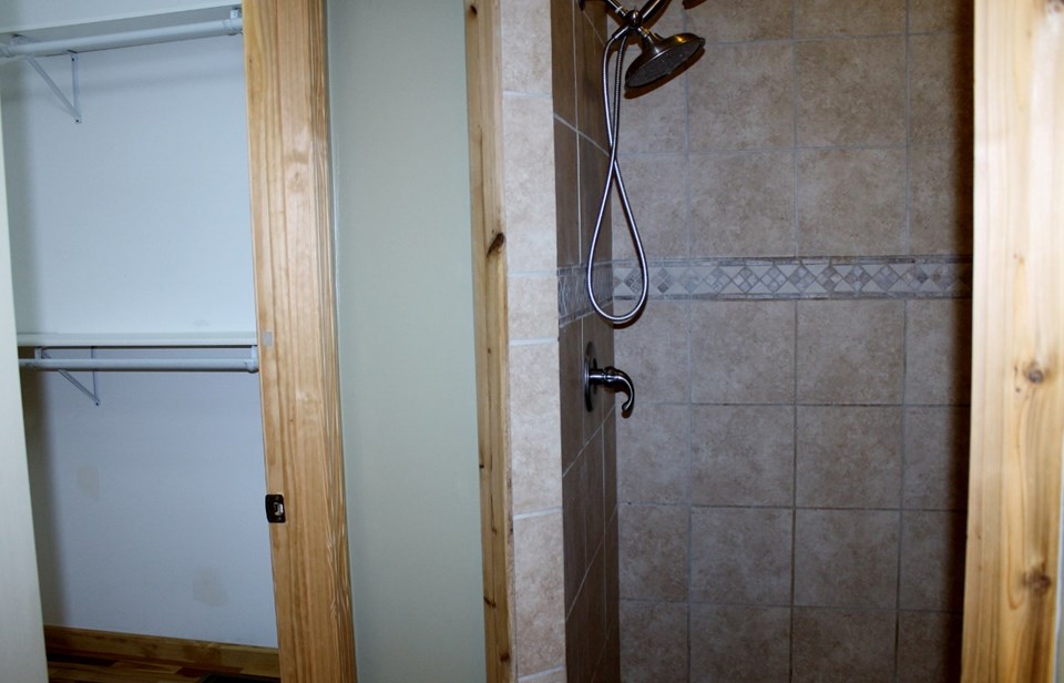walk-in closet, tiled shower and water closet