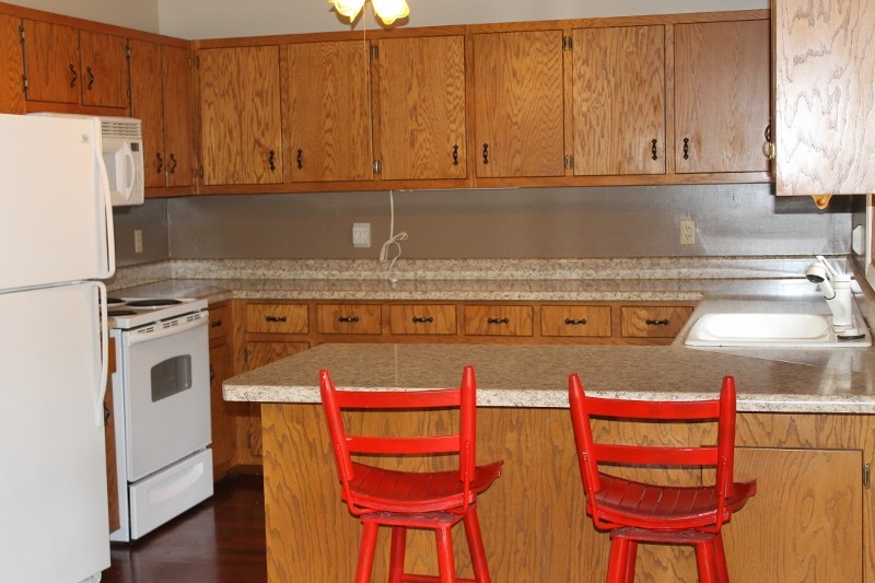 kitchen has new countertops with breakfast bar