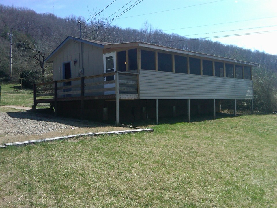 cabin. this cabin is set up as a dining room with tables and a huge kitchen.  screened in porch has outside seating.  could be used for multiple things.
